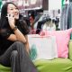 Young woman talking on her cell phone while shopping --- Image by ฉ Ned Frisk/Blend Images/Corbis